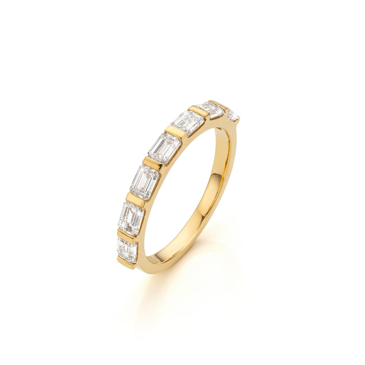 Lume emerald-cut diamond band in yellow gold, angled view
